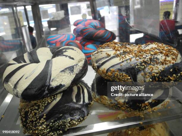 Black and white bagels lie in a glass cabinet of the Bagel Store in Brooklyn, New York, US, 12 January 2018. The Bagel Store in Brooklyn, known for...