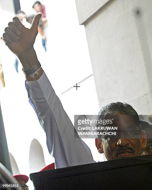 Sri Lanka's ex-army chief and defeated presidential candidate Sarath Fonseka waves to the media after leaving the Magistrate court in Colombo, on May...