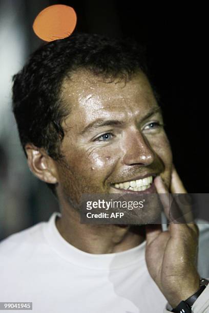 French skipper Romain Attanasio smiles on the "Saveol" monohull after finishing the AG2R La Mondiale sailing race between Concarneau and...