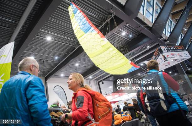 Visitors meet up at the stall of paragliding company Niviuk at the Caravan, Motor and Tourism trade fair in Stuttgart, Germany, 13 January 2018....