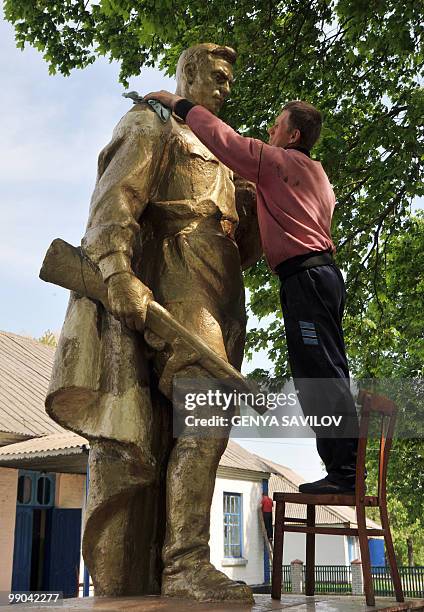 Local resident cleans the Unknown Soldier monument in Medvedivka village on May 6, 2010. Remains of bodies of about 40 Soviet soldiers, who died...