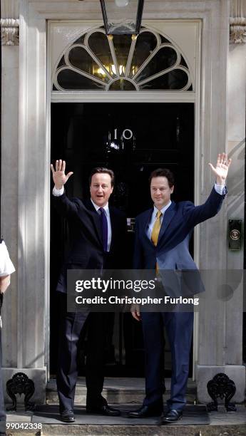 British Prime Minister David Cameron welcomes Deputy Prime Minister Nick Clegg to Downing Street for their first day of coalition government on May...