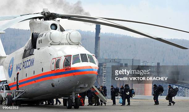 Russian Emergency Ministry servicemen walk near a helicopter as they take part in the rescue operation at Raspadskaya mine in the town of...