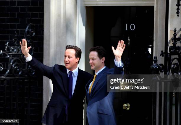 British Prime Minister David Cameron welcomes Deputy Prime Minister Nick Clegg to Downing Street for their first day of coalition government on May...