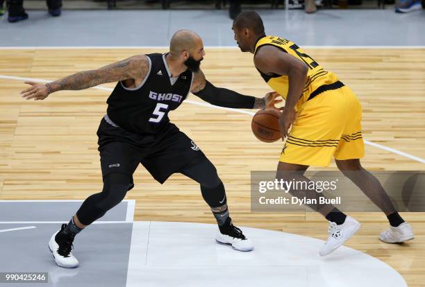 Carlos Boozer of Ghost Ballers guards Metta World Peace of Killer 3s during week two of the BIG3 three on three basketball league at United Center on...