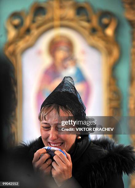 Relative of a miner killed in explosions at the Raspadskaya mine, cries during a funeral ceremony in the city of Mezhdurechensk in the west Siberian...