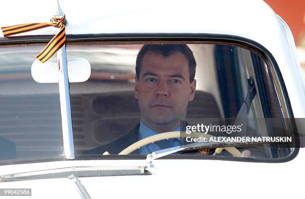 Russian President Dmitry Medvedev sits in a vintage Pobeda car at a World War Two memorial, a monument to the legendary 28 heroes from the Panfilov...