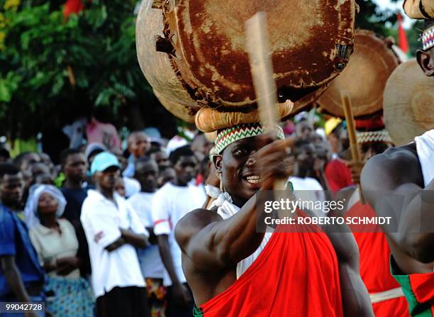 Traditional Burundian drummer plays the drum he carries on his head during a political rally at a sports field in Bujumbura on May 11, 2010. Some 3.5...