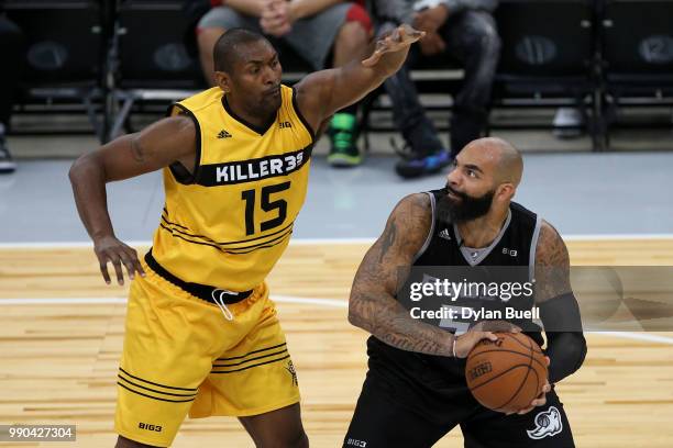 Carlos Boozer of Ghost Ballers is guarded by Metta World Peace of Killer 3s during week two of the BIG3 three on three basketball league at United...