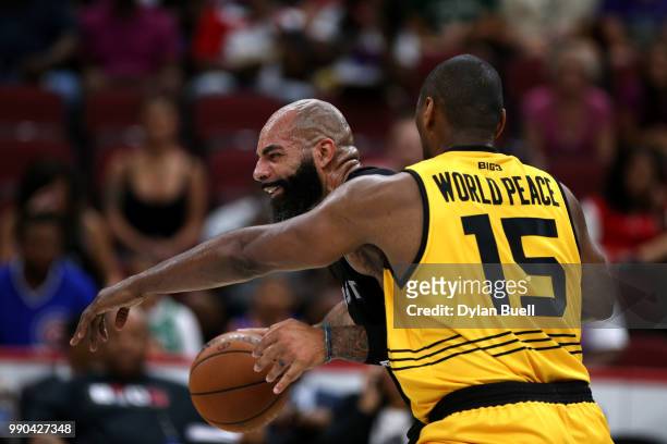 Carlos Boozer of Ghost Ballers is guarded by Metta World Peace of Killer 3s during week two of the BIG3 three on three basketball league at United...