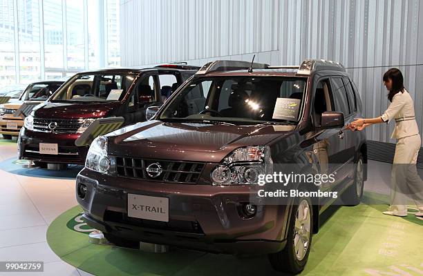 Nissan Motor Co. Vehicles are displayed in a showroom at the company headquarters in Yokohama, Japan, on Wednesday, May 12, 2010. Nissan Motor Co.,...