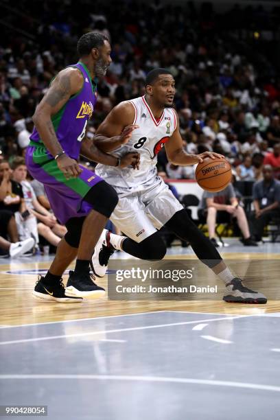 Qyntel Woods of 3 Headed Monsters guards James White of Trilogy during week two of the BIG3 three on three basketball league at United Center on June...