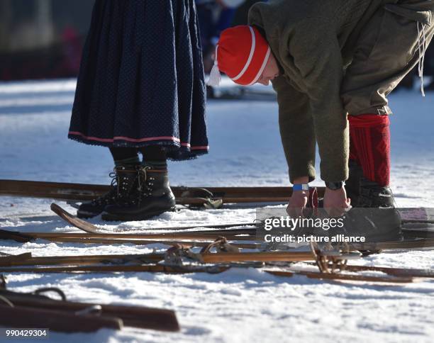 Equipped with wooden skis and wearing traditional clothing, skiers prepare for a nostalgic ski race in Kruen, Germany, 13 January 2018. Photo:...