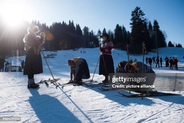 Equipped with wooden skis and wearing traditional clothes, skiers prepare for a nostalgic ski race in Kruen, Germany, 13 January 2018. Photo:...