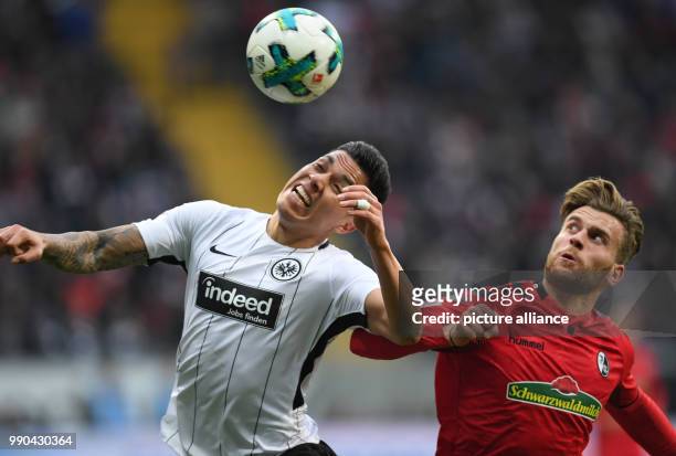 Frankfurt's Carlos Salcedo and Freiburg's Lucas Hoeler vie for the ball during the German Bundesliga football match between Eintracht Frankfurt and...