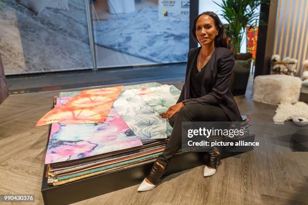 Barbara Becker sits on top of yoga mats she designed. She is currently presenting her new collection at Domotex in Hanover, Germany, 13 January 2018....