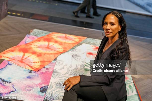 Barbara Becker sits on top of yoga mats she designed. She is currently presenting her new collection at Domotex in Hanover, Germany, 13 January 2018....