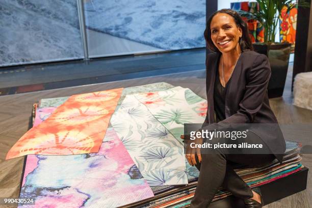Barbara Becker sits on top of yoga mats she designed. She is currently presenting her new collection at Domotex in Hanover, Germany, 13 January 2018....