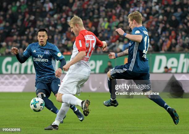 Augsburg's Martin Hinteregger , and Bobby Wood and Andre Hahn of Hamburg vie for the ball during the German Bundesliga football match between FC...