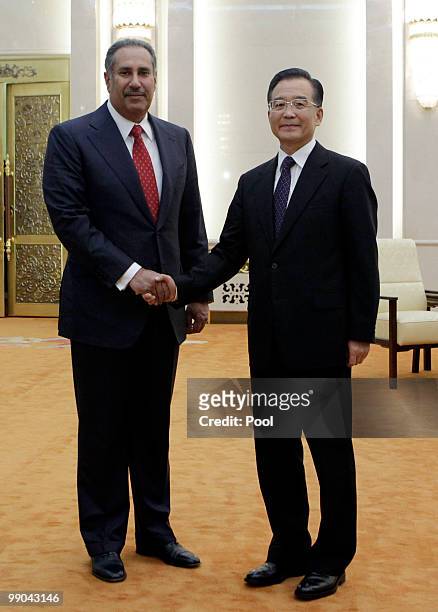 China's Premier Wen Jiabao shakes hands with Qatar's Prime Minister Sheikh Hamad Bin Jassim Bin Jabr Al-Thani during a meeting at the Great Hall of...