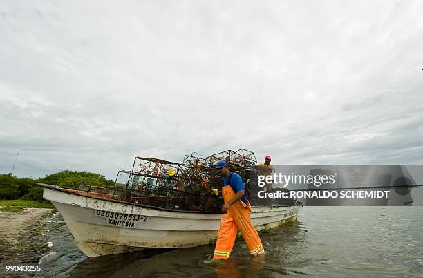 Mexican fisherman Luis Robles takes his boat out of the water in Puerto San Carlos, Baja California state, Mexico, on September 1, 2009. Jimena was...