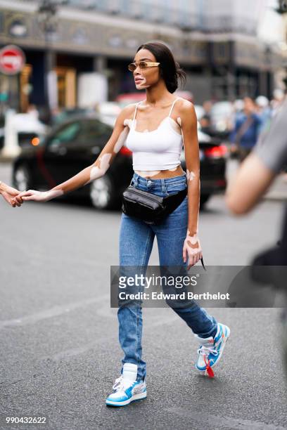 Winnie Harlow , outside Schiaparelli, during Paris Fashion Week Haute Couture Fall Winter 2018/2019, on July 2, 2018 in Paris, France.
