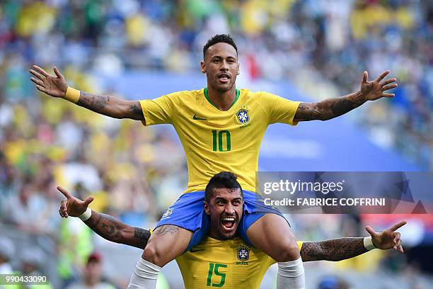 Brazil's forward Neymar celebrates with Brazil's midfielder Paulinho after scoring the opening goal during the Russia 2018 World Cup round of 16...