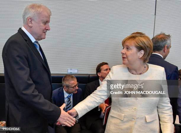 German Chancellor and leader of the Christian Democratic Union Angela Merkel and German Interior Minister and leader of the Bavarian Christian Social...