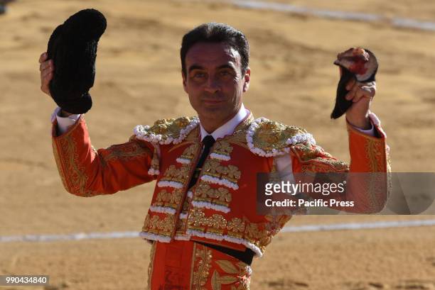 Spanish bullfighter Enrique Ponce holds an ear after he finished the bull during a bullfight at the 'La Chata' bullring in Soria, north of Spain.