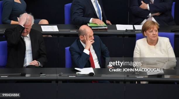German Interior Minister Horst Seehofer, German Finance Minister and Vice-Chancellor Olaf Scholz and German Chancellor Angela Merkel attend a session...