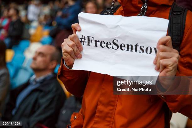 People hold banners, with the words &quot;Oleg Sentsov, Ukraine with you!&quot; during a flash mob at the NSC Olympiyskiy Stadium in Kyiv on July 2...