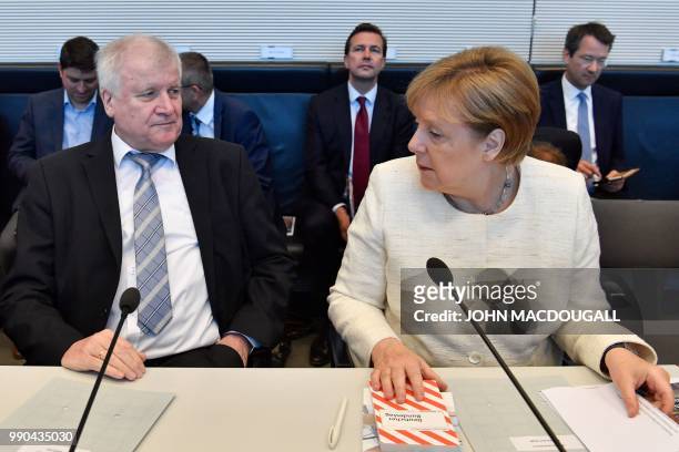 German Chancellor and leader of the Christian Democratic Union Angela Merkel and German Interior Minister and leader of the Bavarian Christian Social...