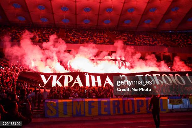 People hold banners, with the words &quot;Oleg Sentsov, Ukraine with you!&quot; during a flash mob at the NSC Olympiyskiy Stadium in Kyiv on July 2...