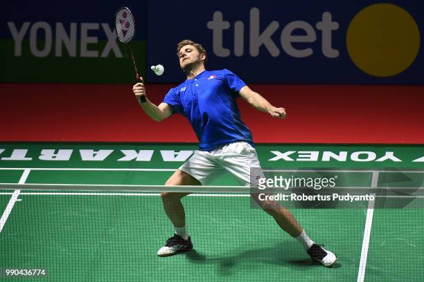 Brice Leverdez of France competes against Chen Long Of China during the Men's Singles Round 1 match on day one of the Blibli Indonesia Open at Istora...