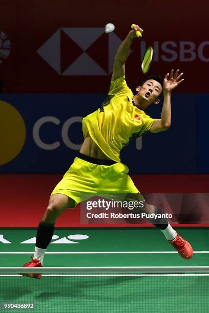 Chen Long of China competes against Brice Leverdez of France during the Men's Singles Round 1 match on day one of the Blibli Indonesia Open at Istora...