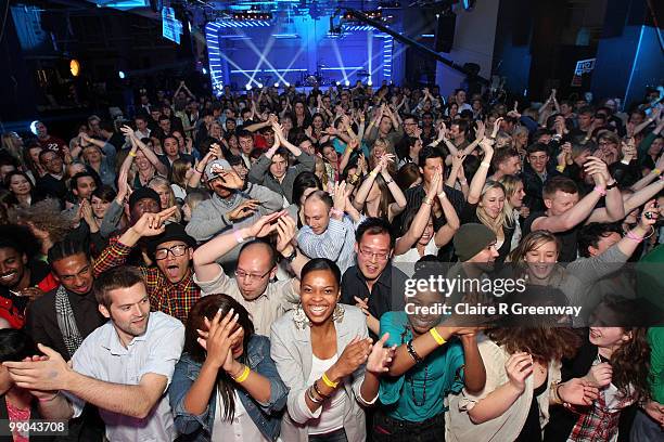 Fans dance as they watch bands perform live on stage during a recording of the 'Evo Music Rooms' for Channel 4, in association with Punto Evo, at The...