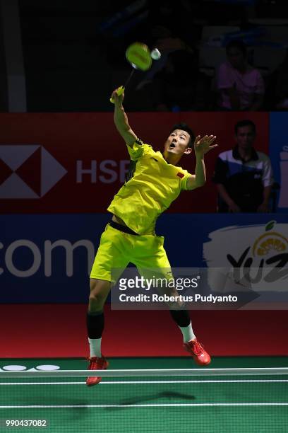 Chen Long of China competes against Brice Leverdez of France during the Men's Singles Round 1 match on day one of the Blibli Indonesia Open at Istora...