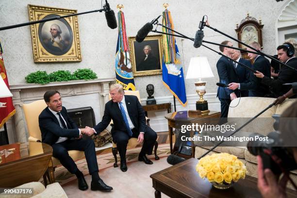 President Donald J. Trump shakes hands with Mark Rutte, Prime Minister of the Netherlands, during a meeting in the Oval Office of the White House on...