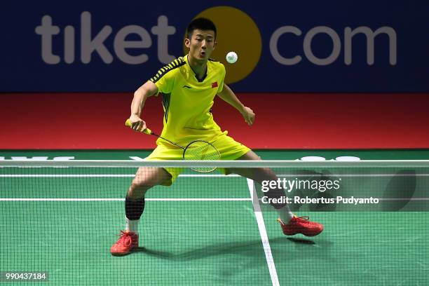 Chen Long of China competes against Brice Leverdez of France during the Men's Singles Round 1 match on day one of the Blibli Indonesia Open at Istora...