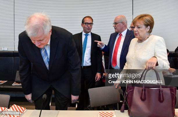 German Chancellor and leader of the Christian Democratic Union Angela Merkel watches as German Interior Minister and leader of the Bavarian Christian...