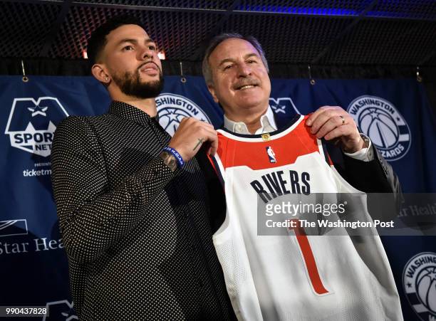 President of basketball operations Ernie Grunfeld, right, poses with newest acquisition, Austin Rivers, left, as the Wizards hold a press conference...