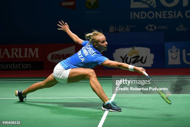 Mia Blichfeldt of Denmark competes against Michelle Li of Canada during the Women's Singles Round 1 match on day one of the Blibli Indonesia Open at...