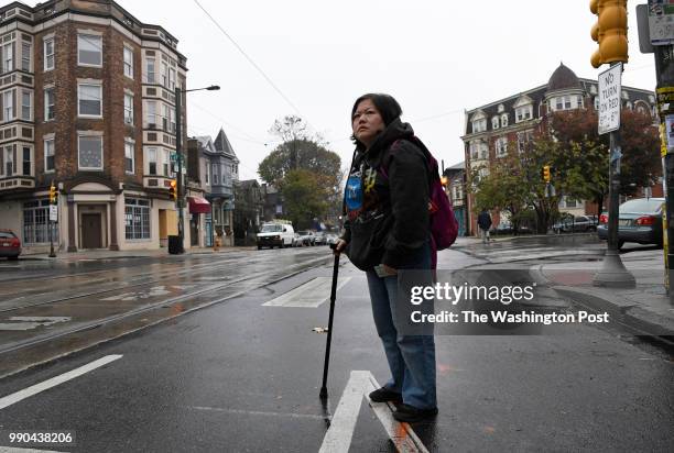 Min Jung of Philadelphia, PA, waits for a trolley to go to her physical therapy appointment in Philadelphia on November 13, 2017. Min suffers from...