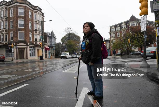 Min Jung of Philadelphia, PA, waits for a trolley to go to her physical therapy appointment in Philadelphia on November 13, 2017. Min suffers from...