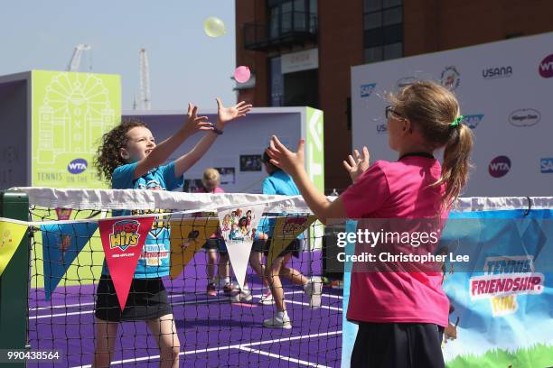 Young tennis fans take part in the Miss Hits lessons during the WTA Tennis On The Thames in Bernie Spain Gardens on June 28, 2018 in London, England.