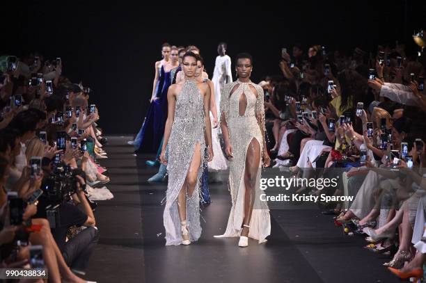 Models Cindy Bruna and Maria Borges lead the finale during the George Hobeika Haute Couture Fall Winter 2018/2019 show as part of Paris Fashion Week...