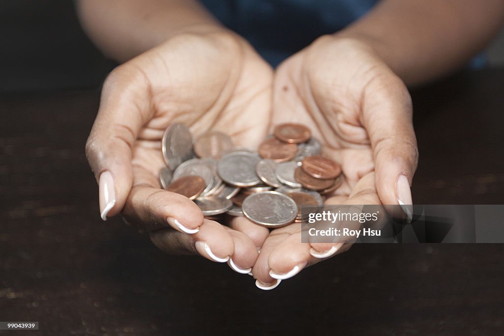 Black woman holding coins