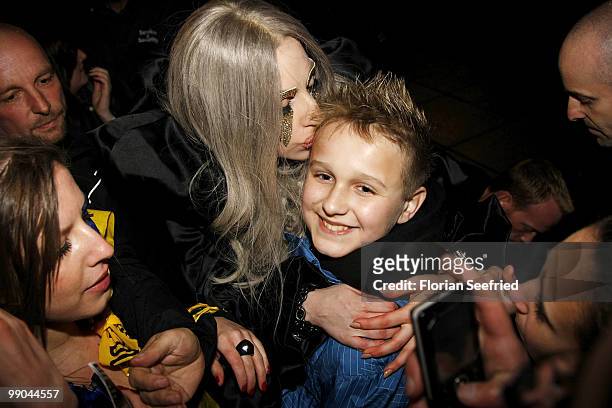 Lady Gaga kisses a fan during she leaves the O2 World after her concert on May 11, 2010 in Berlin, Germany.