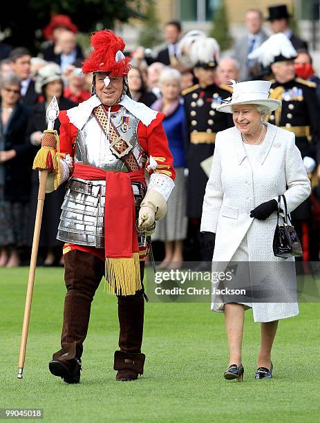 Queen Elizabeth II laughs as she reviews the Company of Pikemen and Muskateers at HAC Armoury House on May 12, 2010 in London, England.