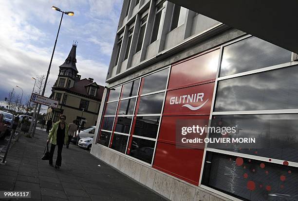 Man walks past a branch of the Icelandic bank Glitnir in Reykjavik on October 8, 2088. The Icelandic state has officially taken control of the...